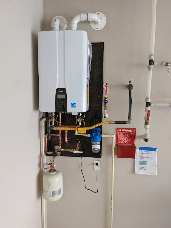 Professional plumber installing copper piping in a Guthrie home